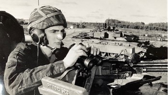 Jason Cooper in military uniform on tank