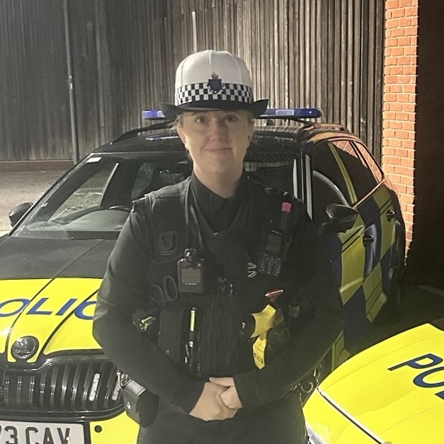 PC Lauren Hobkirk standing in front of police car