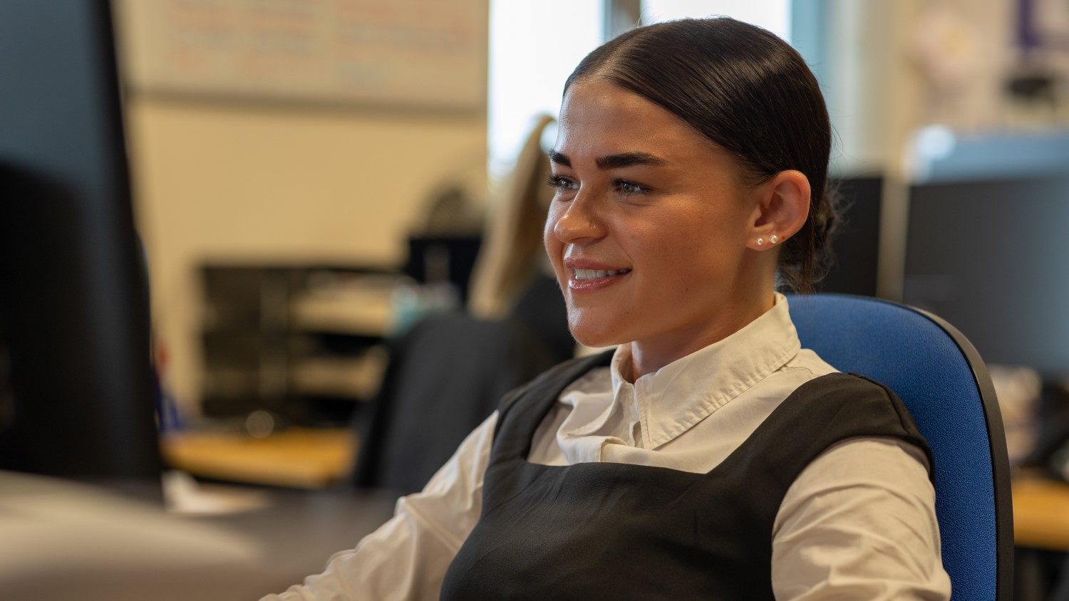Young female detective sitting at desk
