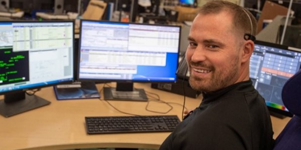 A staff member smiling to camera