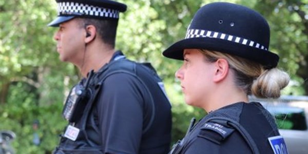 A male and a female special constable looking to the left