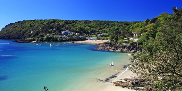 View of beach and coastline, bright blue sea and calm water